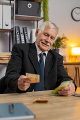 Rich senior businessman working on laptop PC counting money euro cash calculate earnings income...