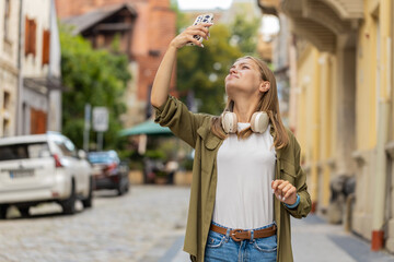 Young female tourist woman trying to catch a communication signal and Internet on mobile phone,...