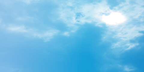 Blue sky, sun, clouds. A peaceful moment with underlying complexity. A reflection of the sky on thin clouds. Hidden emotions beneath a bright exterior like feeling melancholic on a good day background