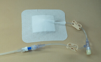 Huber (gripper) needle fully inserted into a simulated subcutaneous port and secured with an opaque...