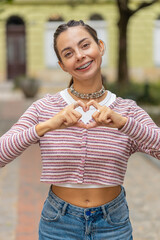I love you. Caucasian woman makes symbol of love, showing heart sign to camera, express romantic...