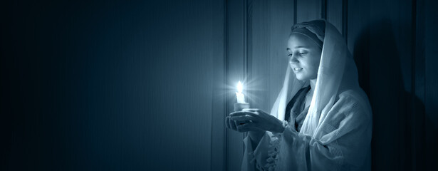 Young pretty girl with a candle