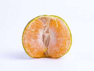 Half-peeled ripe tangerine with juicy orange flesh isolated on white background. Fresh tropical...