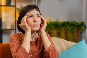 Displeased Caucasian young woman rubbing temples to cure headache problem, suffering from tension...