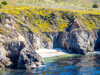 Secluded cove with yellow cliffs and turquoise water, Big Sur coast