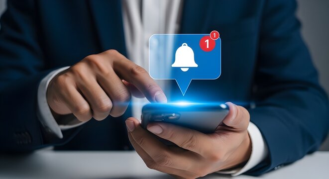 Person in a suit using a smartphone with a notification bubble showing a bell icon and a number one