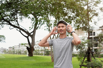 A man in sportswear wearing earphones and running.