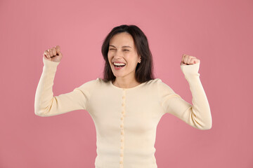 Portrait of surprised woman on pink background