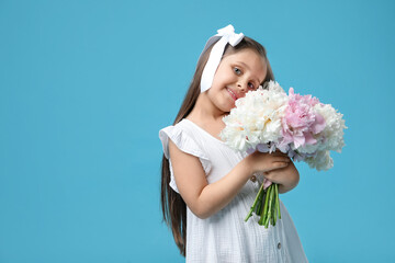 Cute little girl with bouquet of beautiful peonies on light blue background, space for text