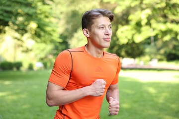 Sporty man running in park. Healthy lifestyle
