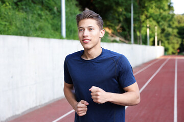 Sporty man running at stadium. Healthy lifestyle