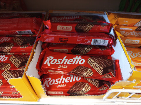 Zvyagel, Ukraine - July 10, 2025: Roshen Roshetto Dark chocolate wafers stacked in colorful packaging on store shelf, showcasing delicious snack options for chocolate lovers