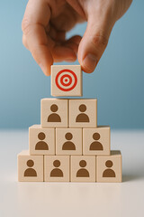 Leadership and Team Target Concept with Wooden Blocks Pyramid and Hand Placing Goal Icon