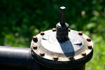 Close-up of a well-maintained industrial valve in natural sunlight