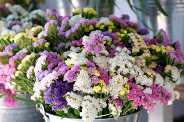Vibrant bouquet of statice flowers brightening a rustic market stall