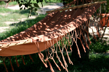Relaxing afternoon in a shaded hammock under lush green trees