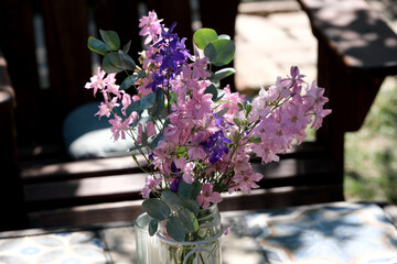 Colorful bouquet of flowers on a wooden outdoor table