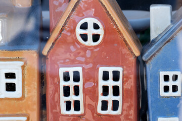 Charming ceramic houses displayed in a quaint shop window
