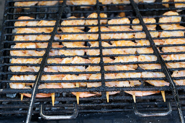 Juicy shrimp grilling over charcoal at a lively summer barbecue