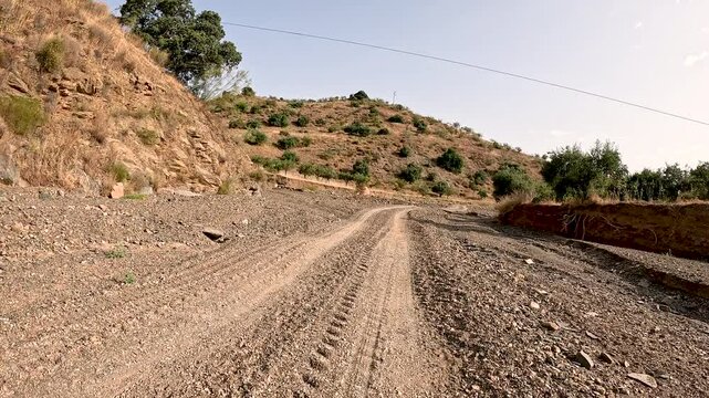 Camino Mozarabe de Santiago - a dirt road on a summer landscape between Junta de los Caminos and Almogia, M&aacute;laga, Andalusia, Spain