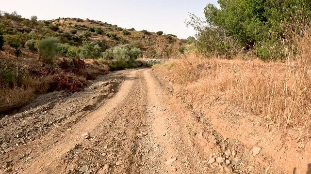 Camino Mozarabe de Santiago - a dirt road on a summer landscape between Junta de los Caminos and Almogia, M&aacute;laga, Andalusia, Spain