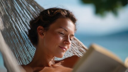 Young woman reading a book comfortably on a hammock by the beach, tranquil and relaxing. Vacation, leisure. Soft light.