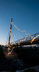 Obraz premium Illuminated Modern CableStay Bridge with Warm LED Lighting.