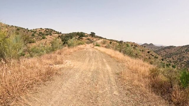 Camino Mozarabe de Santiago - a dirt road on a summer landscape between Junta de los Caminos and Almogia, M&aacute;laga, Andalusia, Spain