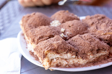 Cold baklava with cacao on a white plate close up	