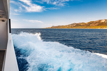 Pleasure boat leaving white wake trail cruising in the sea