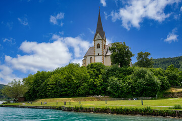 A view of the churches of Maria Wörth on Lake Wöhrtersee in Austria.