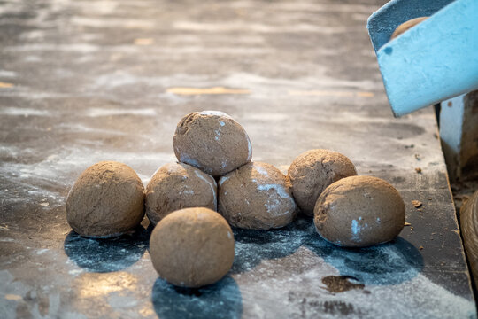 Unbaked Dough Balls on Floured Surface in Bakery - Powered by Adobe