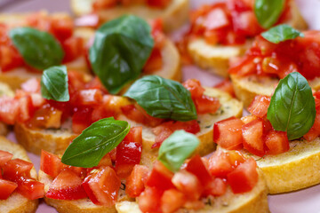 Freshly Made Italian Appetizer with Juicy Tomatoes, Basil Leaf, and Toasted Bread, close-up.