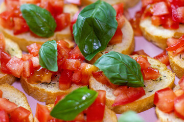 Freshly Made Italian Appetizer with Juicy Tomatoes, Basil Leaf, and Toasted Bread, close-up.