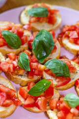 Freshly Made Italian Appetizer with Juicy Tomatoes, Basil Leaf, and Toasted Bread, close-up.