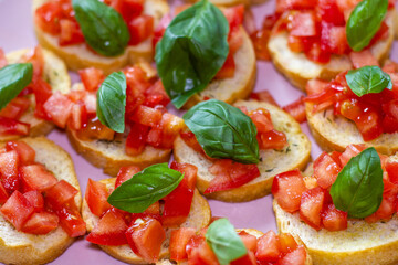 Freshly Made Italian Appetizer with Juicy Tomatoes, Basil Leaf, and Toasted Bread, close-up.