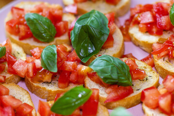 Freshly Made Italian Appetizer with Juicy Tomatoes, Basil Leaf, and Toasted Bread, close-up.