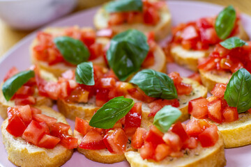 Freshly Made Italian Appetizer with Juicy Tomatoes, Basil Leaf, and Toasted Bread, close-up.