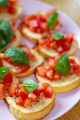 Freshly Made Italian Appetizer with Juicy Tomatoes, Basil Leaf, and Toasted Bread, close-up.