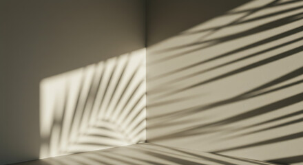 Shadows of a palm leaf on a neutral wall.