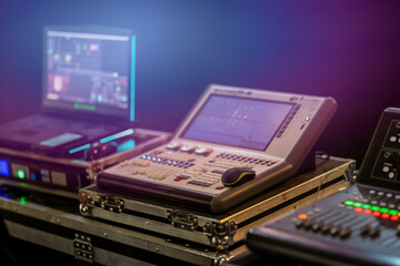 Lighting and sound control panel with laptop during live event setup. Professional stage equipment...