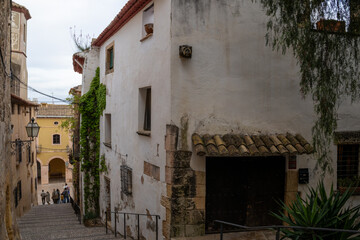 Fototapeta premium Scenic medieval street in Altafulla, Spain, with colorful facades, stone walls, and vibrant southern charm.