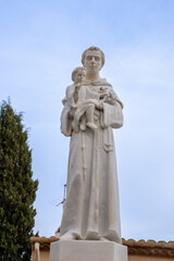 Historic sculpture stands proudly by Parròquia Sant Martí and Altafulla Castle in Catalonia. A quiet symbol of medieval charm.