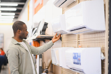 Customer choosing air conditioner in electronics store