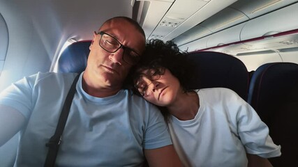 Couple Relaxing and Sleeping Together During a Comfortable Plane Flight