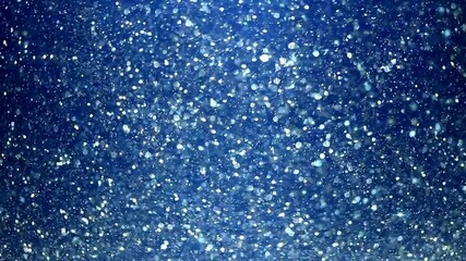 Falling snowflakes and shiny ice crystals drift across a blue winter sky, evoking holiday warmth and seasonal charm - Powered by Adobe