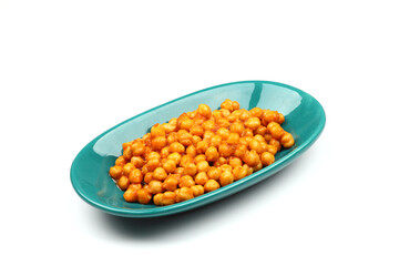 Chickpea dish from legumes in a green plate on a white background.