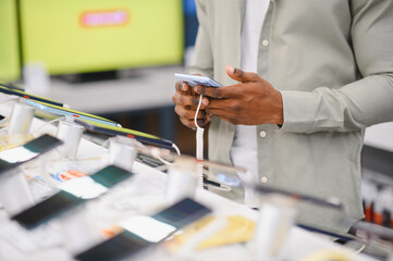Customer trying new smartphone in electronics store