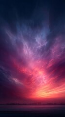 Fototapeta premium Vivid Pink and Purple Sunset Sky Over a Misty Landscape