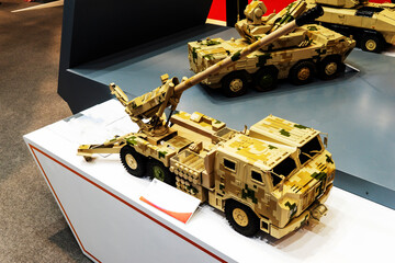Military cars, trucks, models on a white background, at a military exhibition in Baku, Azerbaijan.